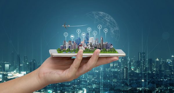 Smart city and Internet of things (IOT) on smartphone in hand, objects icon connecting together, Internet networking concept with background modern city blurred.